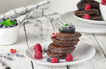 homemade pancakes with chocolate, summer fresh juicy fragrant berries