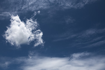 Naklejka na ściany i meble Dramatic blue sky with fluffy clouds texture background.