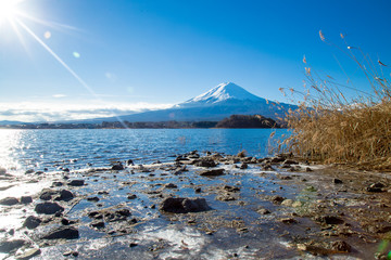 A view from coast overlooking the Kawaguchi lake and the Fuji mountain in the distance. Fujisan mountain reflection on water with sunrise landscape, Lovely day at view on Fuji and ice on water