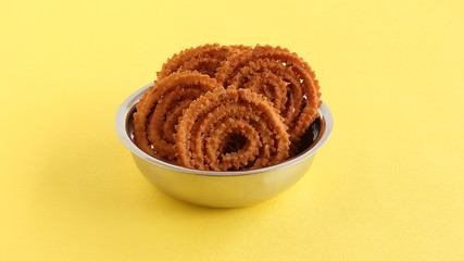 Chakli or chakkuli is a traditional, popular, vegetarian and delicious Indian savory snack, typically made during some festivals, in a steel bowl.