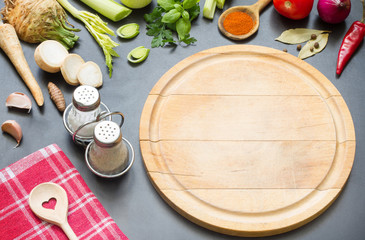 Cooking in the kitchen food background concept with spices  vegetables and cutting board
