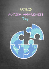 World Autism Awareness day with chalk doodle globe in puzzle jigsaw pieces on school black chalkboard