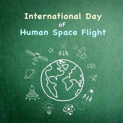 International day of human space flight announcement on grunge green chalkboard doodle drawing
