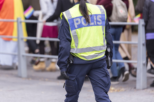 Swedish Police Officer with Reflective Vest and Gun.