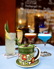 Colorful cocktails standing on the table on bar's terrace outdoor 