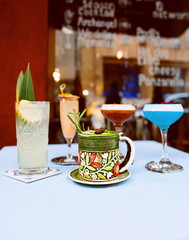 Colorful cocktails standing on the table on bar's terrace outdoor 