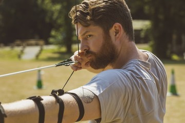 Man practicing archery at boot camp