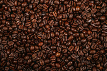 Roasted brown coffee beans background. Flatlay style, messy pattern.