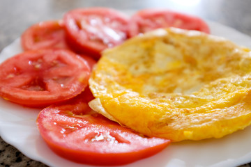 Fresh plain omelette with tomatoes