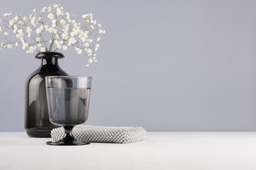 Elegant decor dressing table in minimalist style - black vase with flowers, glass, cosmetic...