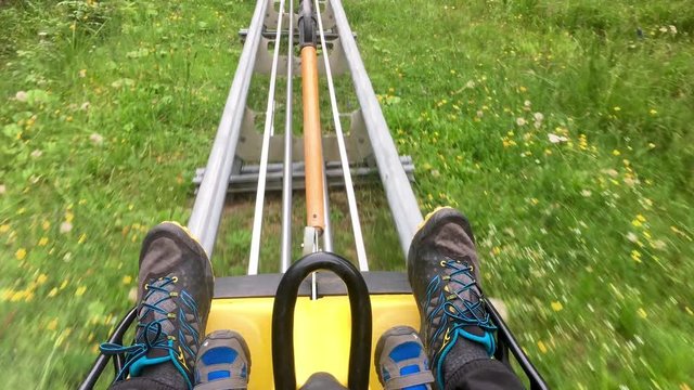 Rollercoaster Train Getting Up A Mountain With A Father's And A Kid's Feet