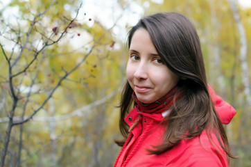 Fototapeta premium Face portrait of young caucasian woman with long brown hair in red jacket and stoles.
