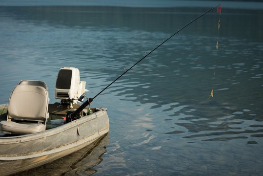 Motorboat with fishing rod on a river