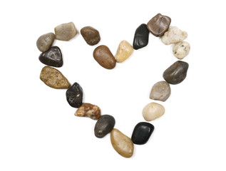 Pebbles, rocks laid out in heart shape isolated on white background and texture, top view
