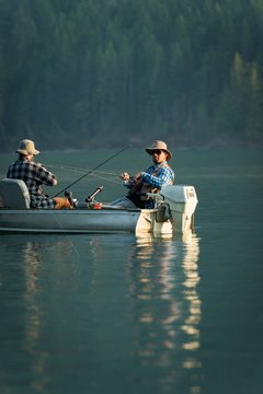 Two Fishermen Fishing In The River