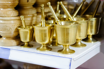 New brass mortars for spices on the shelf in the store