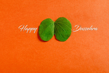 Happy Dussehra greeting card , green leaf and rice