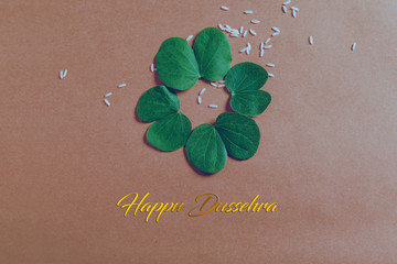 Happy Dussehra greeting card , green leaf and rice