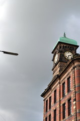 a brick building with clocks