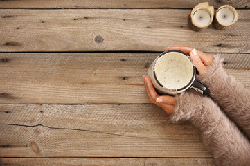 Mug of hot coffee in woman hands