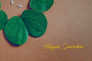 Happy Dussehra greeting card , green leaf and rice