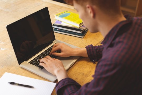 College Student Using Laptop In Library