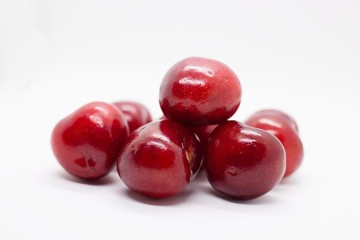 pile of cherries on white