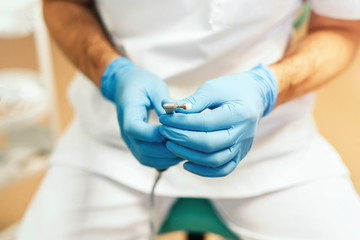 Closeup shot of dentists hands holding dental tool