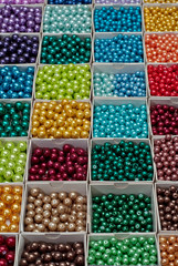 close up multi colored beads heap in box