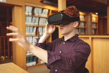 College student using virtual reality headset in library