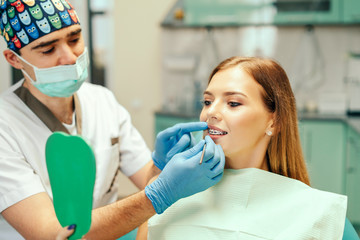 Dentist showing result of treatment for the patient.