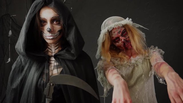 Horrifying female Death Reaper and dead wife scary zombie bride wearing mind blowing heavy professional Halloween makeup