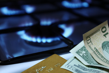 money and bank cards on the background of the gas stove