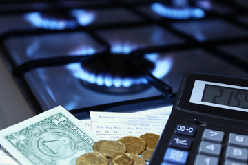 calculator and money in the background of a gas stove