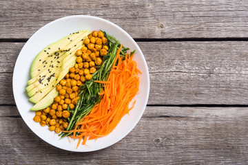 Buddha bowl with avocado , cucumber , carrot and chickpea