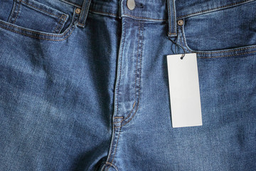 Blue jeans with blank white price label tag