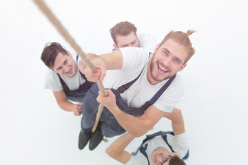 view from the top.smiling engineer ,climbing up the rope