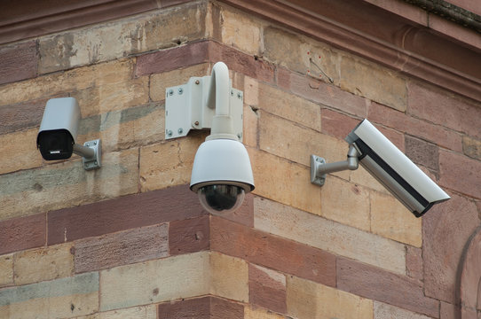 closeup of security camera in the city on building facade