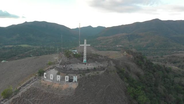 Aerial drone shot away from people at the city sign, on the top of Mount Tapyas, at Coron island, in Philippines, Asia
