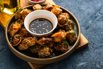 Fried dumplings with soy sauce with pepper and green onions. Asian cuisine
