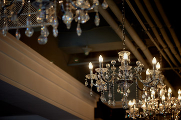 Several crystal chandeliers under the ceiling. Luxury and brilliance