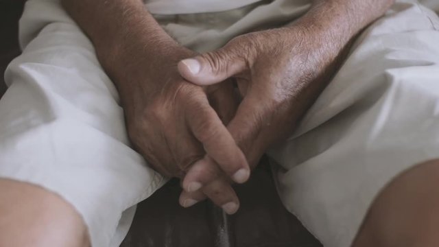 Cinematic shot Closeup of an Elderly man's hands holding a cane.