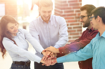 Group of people hands together partnership teamwork.
