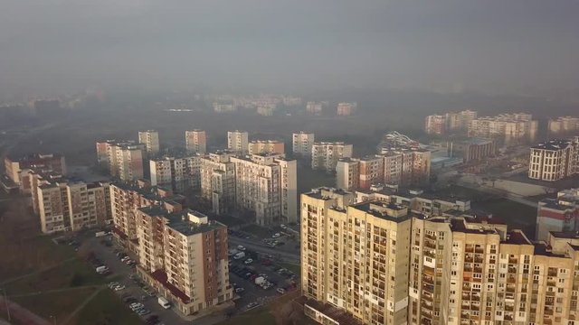 Flying over a concrete living apartment area in east Europa with many birds flying around the drone