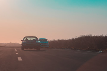 Obraz na płótnie Canvas car asphalt road and sun rising at skyline