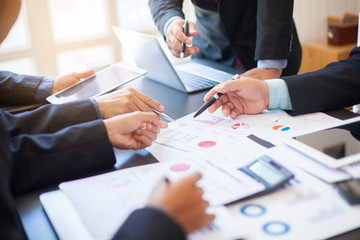Close up of hands and stationery of Business people counting on calculator sitting at the table.