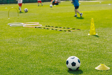 Physical Education Class. Soccer Training Session on the Grass Sports Field. Football Training Equipment. Traditional Soccer Ball, Speed and Agility Training Ladder, Cones. Kids Playing Sports Outdoor