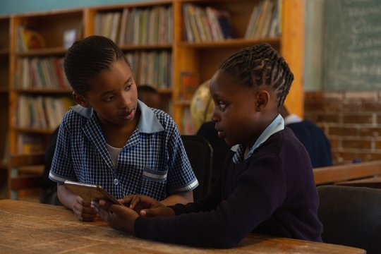 Schoolkids using digital tablet in classroom