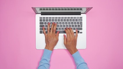 Woman hands typing on keyboard of silver laptop - Powered by Adobe