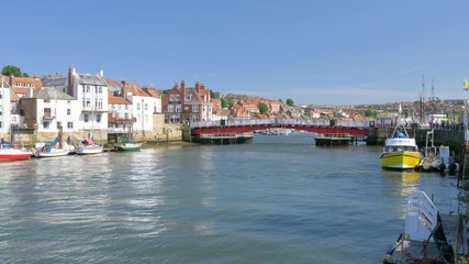 View of boats, yachts, and the swing bridge in Whitby Harbour on a beautiful Summer evening.